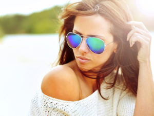 attractive woman wearing aviator sunglasses on beach