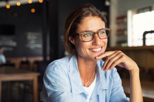 middle age woman wearing glasses looking out window